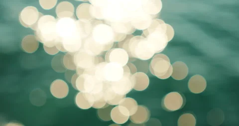 Blurred bokeh light on turquoise Mediterranean Sea water surface at Capri Island Stock Footage 345538480