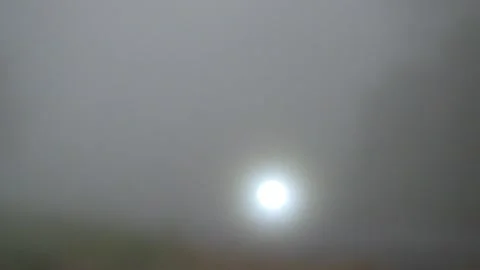 Blurred car headlights passing through the foggy road Stock Footage 291615018