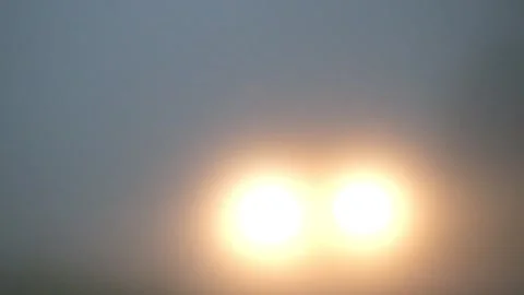 Blurred car headlights passing through the foggy road Video stock 291615019
