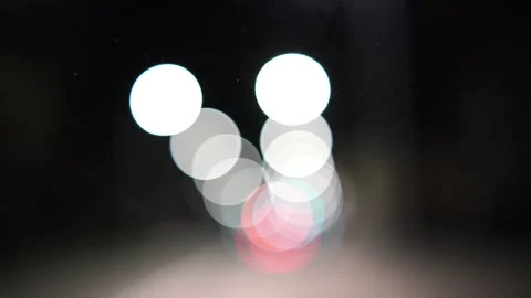 Blurred car lights bokeh in the evening city. Defocused headlights and street Stock Footage 230327307
