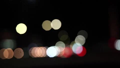 Blurred car lights bokeh in the evening city. Defocused headlights and street Stock Footage 253432161