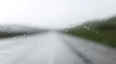Blurred car lights passing from rain on car window Stock Footage 63377478