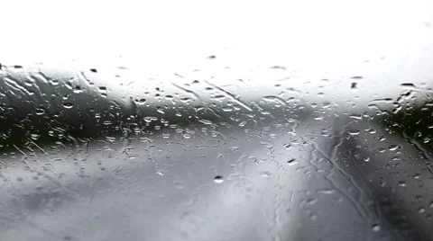 Blurred car lights passing from rain on car window Video stock 63377500