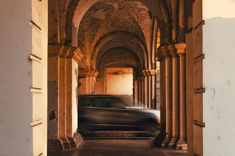 Blurred car passing under stone arches, symbolizing fast urban life, transp.. Stock Photos