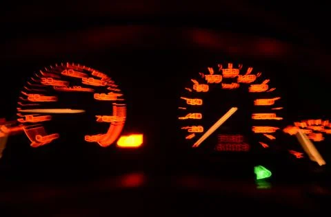 Blurred car speedometer during driving. Illuminated dashboard instruments 스톡 사진