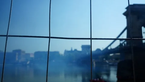 Blurred Chain Bridge and helicopter behind security fence in Budapest Stock Footage 103167461