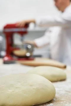 Blurred Chef Using Dough Mixer In Kitchen Stock Photos