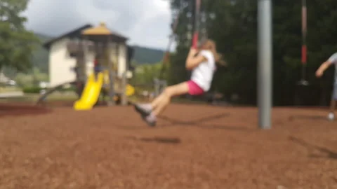 Blurred children playing in a park Stock Footage 132271393