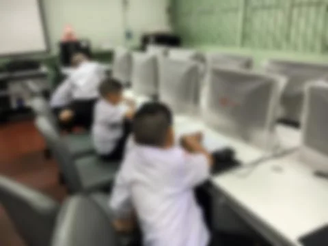 Blurred children student during study computer e-learning in the classroom. Stock Photos