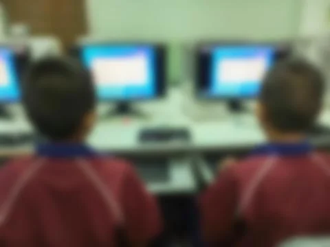 Blurred children student during study computer e-learning in the classroom. Stock Photos