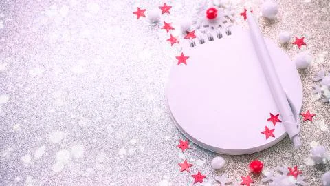 Blurred christmas composition with notepad, pen, snowflakes Stock Photos