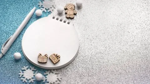 Blurred christmas composition with notepad, pen, snowflakes Stock Photos