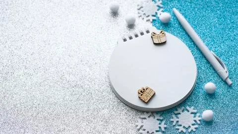 Blurred christmas composition with notepad, pen, snowflakes Stock Photos