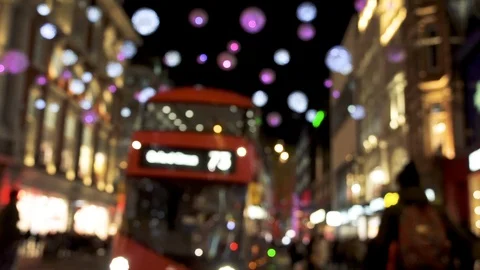 Blurred Christmas lights, red buses and black cabs on busy Oxford Street. Video stock 100273260