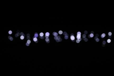 Blurred Christmas String Lights on Dark Background, Defocused Fairy Lights Stock Photos