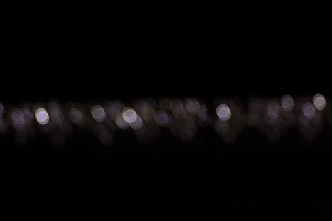 Blurred Christmas String Lights on Dark Background, Defocused Fairy Lights Stockfoto's