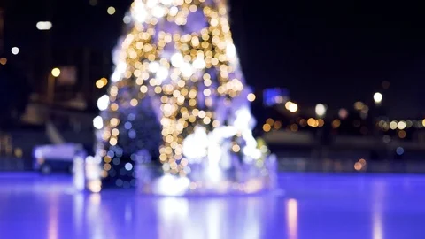 Blurred Christmas tree in bokeh effect with Garland lights blinking on ice rink. Stock Footage 122006249