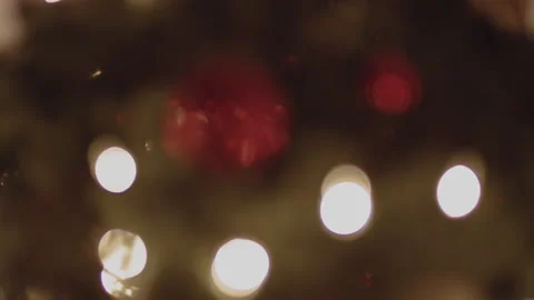 Blurred Christmas Tree Lights and Red Sphere Stock Footage 172265076