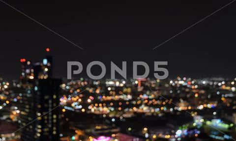Blurred city lights bokeh illuminated at night Stock Photos