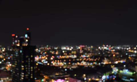 Blurred city lights bokeh illuminated at night Stock Photos