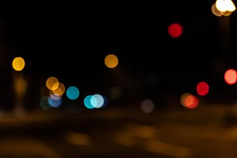 Blurred city lights of an intersection at night Stock Photos