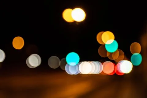 Blurred city lights of an intersection at night Stock Photos