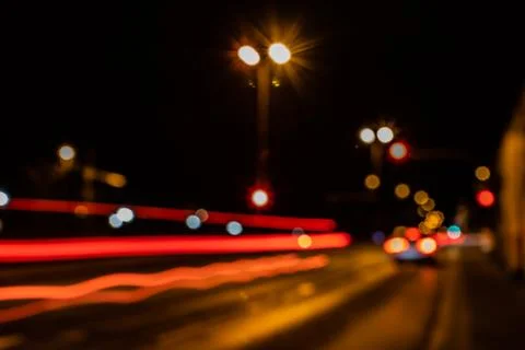 Blurred city lights of an intersection at night Stock Photos