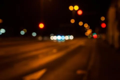 Blurred city lights of an intersection at night Stock Photos