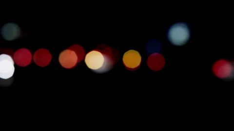 Blurred city lights at night creating a bokeh effect Stock Footage 329816041