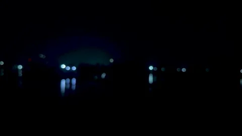 Blurred cityscape at night with glowing lights reflecting on water in a ser.. Stock-Footage 340220662