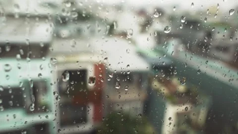 Blurred Cityscape Through Window Glass with rain drops Stock Footage 339286046