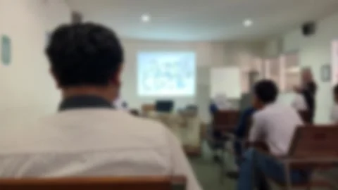 Blurred classroom background. A class listening a teacher give lecture. Stock Footage 256858253