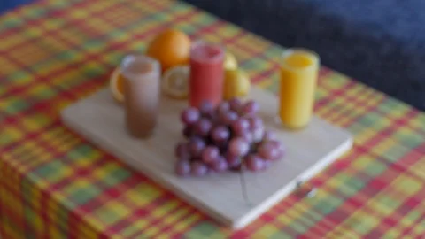 Blurred to clear shot of fruit platter with juices. wood plate and madras table  Stock Footage 112030647