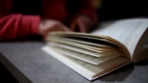 Blurred close-up book being read by a female. Stock Footage 169886304