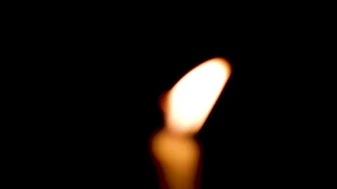 Blurred close-up of the flame burning on the candle with isolated on a black bac Stock Footage 159085692