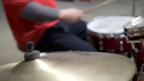 Blurred Close up of man playing drums the drumset in red outfit Stock Footage 104470227