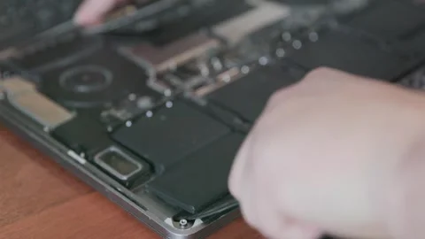 Blurred close-up of the open case of a modern laptop being repaired Stock Footage 337828406
