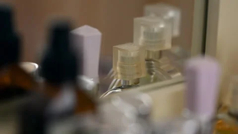 Blurred close up of perfume bottles arranged on a dressing table Stock-Footage 329402895