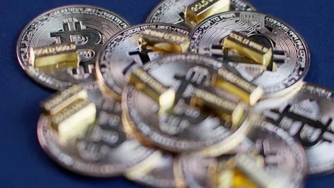 Blurred Closeup Revealing Bitcoin and Gold Bars Stock Footage 299784375