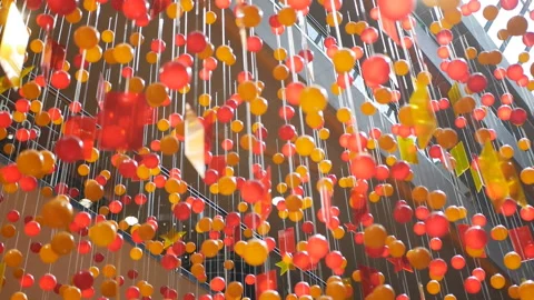 Blurred colored plastic beads hanging at the mall as a decoration Stock Footage 113818079