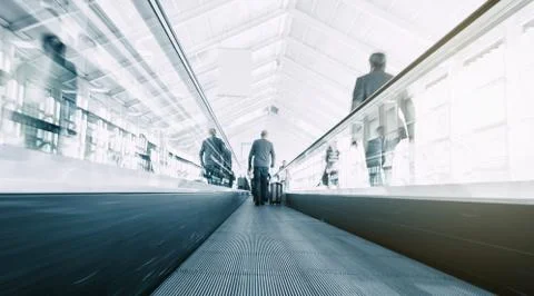 Blurred commuters on a escalator Stock Photos