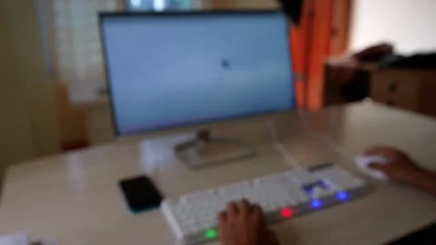 Blurred Computer Workspace Scene, Blurred image of a person using a compute.. Stock Footage 317736912