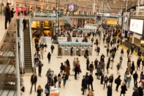 Blurred concept crowded with passengers at train stationin rush hour. Stock Photos