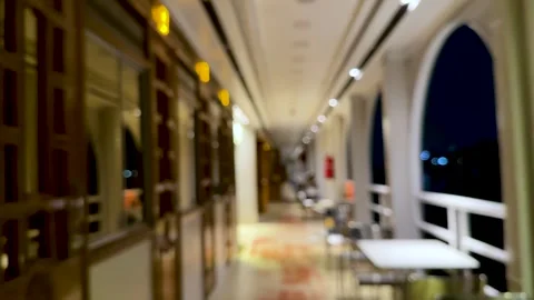 Blurred corridor with warm lighting and reflections creating a serene night.. Vídeos de archivo 340220767