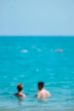 Blurred couple in the ocean Stock Photos