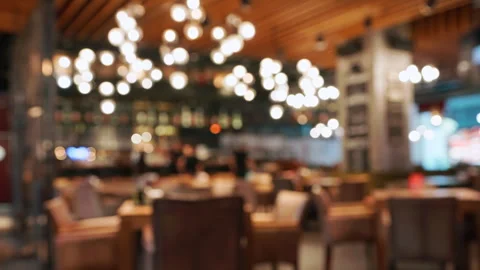 Blurred cozy stylish restaurant interior warm ambient lighting empty tables Stock Footage 292542783