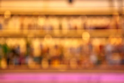 Blurred creative background of restaurant bar with pink desk space. Stock-Fotos