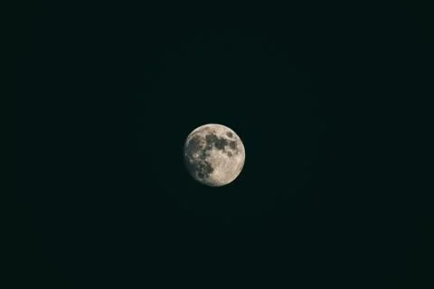 Blurred crescent moon on black background. Stock Photos