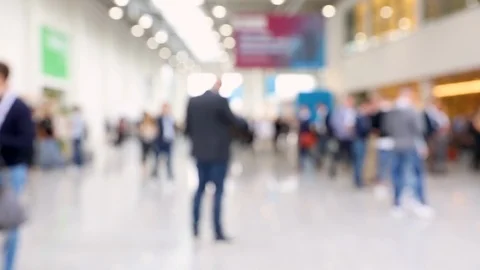 Blurred crowd in a convention hall with a man waiting Video stock 124525793