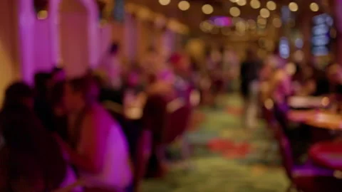 Blurred crowd in dimly lit indoor event with warm bokeh lights and colorful Stock Footage 345609214